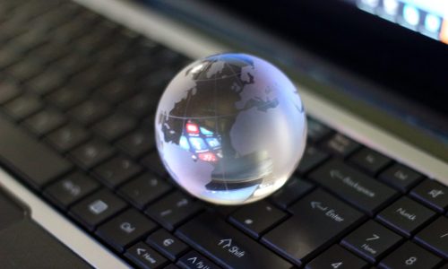 global-technology-glass-orb-on-laptop-keyboard-2026-09-24-04-25-02-utc