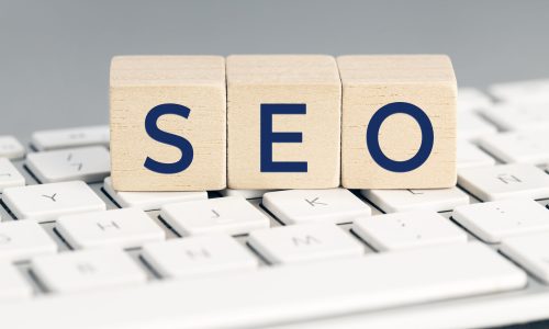 SEO word on wooden blocks on computer keyboard. Search Engine optimization concept